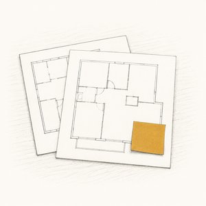 机に並べた2枚の無地の間取り図のうち、手前の1枚にだけ付箋が貼られている線画